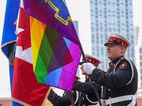 Calgary Fire Department members carry flags during the Pride Parade in downtown on Sunday, September 4, 2022.