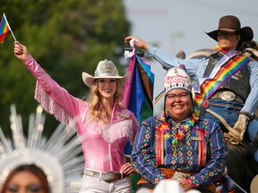 Stampede Princess Jenna Peters and First Nations Princess Sikapinakii Low Horn ride on the Calgary Stampede float during the Pride Parade in downtown on Sunday, September 4, 2022.
