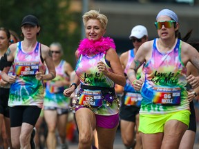 Calgarians race in the Love is Love Mile race before the start of the Pride Parade in downtown on Sunday, September 4, 2022.