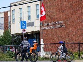 The Canadian flag outside Queen Elizabeth Elementary School in Calgary flies at half-mast following the death of the Queen Elizabeth II on Thursday, September 8, 2022.