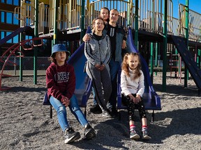 Yuriy and Iuliia Kovalenko were photographed with their daughters Valeriia, 17, Mariia, 9, and Serafyma, 7, near their apartment in Calgary on Saturday, September 24, 2022. The Ukrainian family arrived in Calgary in May and the children are now attending the school in the city.