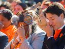 Prime Minister Justin Trudeau and Assembly of First Nations national chief RoseAnne Archibald wipe tears as they take part in the National Day for Truth and Reconciliation during an event at Lebreton Flats in Ottawa on Friday.