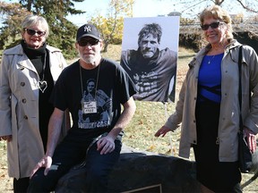 (L-R) Carolyn Whitmee, Shawn Gaudry and Adrienne Read pose during a dedication ceremony in Calgary on Sunday, October 9, 2022 for Paul "Smokey" Wilkinson. The two women are Wilkinson's sisters and travelled from Oshawa, ON for the ceremony. Gaudry was Wilkinson's friend. A green space near 14 St. and Memorial Dr. NW was dedicated in Wilkinson's name.