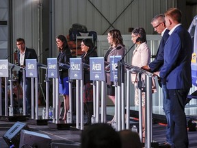 UCP leadership candidates, from left: Todd Loewen, Danielle Smith, Rajan Sawhney, Rebecca Schulz, Leela Aheer, Travis Toews and Brian Jean, participate in a debate in Medicine Hat on July 27, 2022.