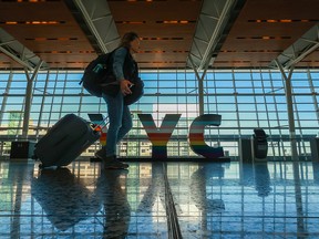 Passengers move through Calgary International Airport on Monday.