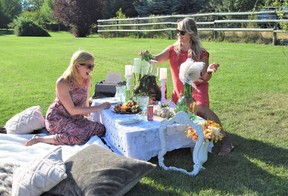 Tanya Kaempf, left, and Kerry MacLeod, enjoy the ‘boho chic’ picnic in Sovereign Park set up by Organizing Chaos by Design.