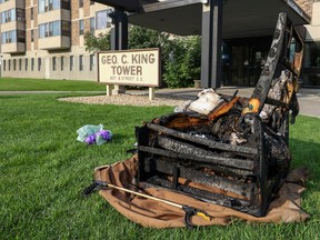 A burned chair and other debris remain outside the George C. King tower in Calgary's East Village after an early morning fire on Thursday, September 1, 2022.