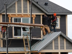 Construction workers work on a new home in the Livingstone community in northwest Calgary on Wednesday January 30, 2019.