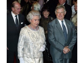 Queen Elizabeth, escorted by Premier Ralph Klein, arrives at a government dinner at the Westin Hotel in Edmonton in 2005. Prince Philip is in the background. Calgary Herald archives