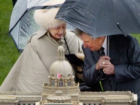 Premier Ralph Klein and Queen Elizabeth, after she cut the Alberta Centennial Cake at Edmonton’s Commonwealth Stadium. Calgary Herald archives