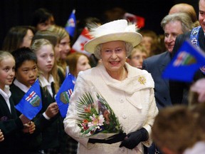 To the cheers of students from King George School, Queen Elizabeth II arrives at the Saddledome in Calgary for a celebration during Alberta's centennial in 2005.