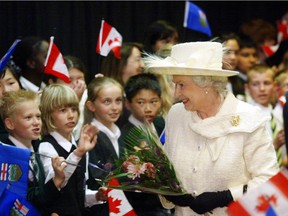 To the cheers of students from King George School, Queen Elizabeth II arrives at the Saddledome. Calgary Herald archives