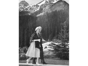 July 11, 1959: Queen Elizabeth walks through the grounds at the Chateau Lake Louise. Accompanying her is D.A. Williams, Chateau manager. Calgary Herald archives.