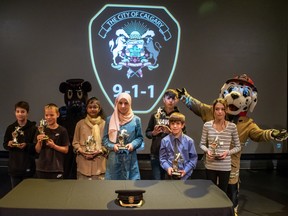 Seven youth received the 911 Heroes Award in a ceremony at the Telus Spark on Friday, Sept. 23, 2022. Each was recognized for remaining calm while calling 911 and providing details on emergencies. Pictured from left is Dylan O'Keefe, Jaxon Erickson, Ramiza Ahmed, Reem Abo Sheffa, Mohamad Kazmuoz, Ben Donegan and Hayley Tibeau.