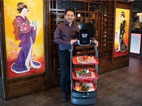 Eric Sit, owner of OMO Teppan and Kitchen along Macleod Trail, says the OMOBOT allows the restaurant's staff to focus on customer experience while the robot waiter handles the delivery of food to tables — never tiring from repeated trips to the kitchen.