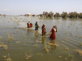 Pakistani women wade through floodwaters as they take refuge in Shikarpur district of Sindh province of Pakistan on Sep. 2, 2022. Pakistani health officials on Thursday reported an outbreak of waterborne diseases in areas hit by recent record-breaking flooding, as authorities stepped up efforts to ensure the provision of clean drinking water to hundreds of thousands of people who lost their homes in the disaster.