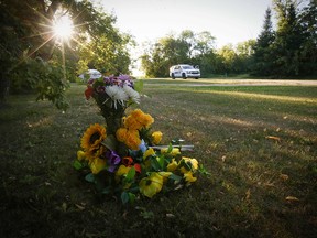 Flowers sit outside a house where one of the stabbing victims was found in Weldon, Sask., on Tuesday.