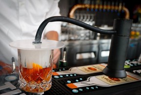 A smoked old fashion called East River Old Fashioned is being mixed up at the Borough Bar + Grill a new contemporary restaurant in Calgary’s University District on Wednesday, September 14, 2022. Al Charest / Postmedia