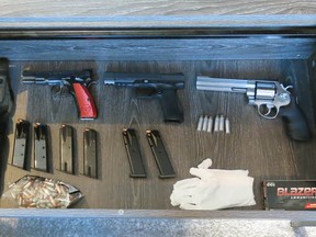 Calgary police display guns seized after executing search warrants in southwest and northeast Calgary at the end of August. CPS data shows police do not know the origin of about half of the guns seized by officers.