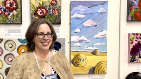 Linda French of Plaid Moose Gallery with her painting Another Day on the Prairies. Courtesy, Leonardo Jenkins