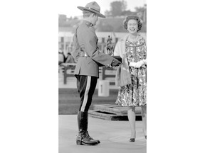 Queen Elizabeth in Calgary in 1973, laughing with an RCMP officer. Photo: Provincial Archives of Alberta.