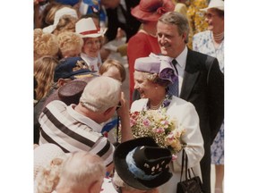 Queen Elizabeth and Prime Minister Brian Mulroney greet a Calgary crowd during the 1990 visit. Calgary Herald archives