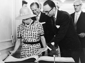 July 5, 1973: Queen Elizabeth with Calgary’s mayor Rod Sykes and Lieutenant Governor of Alberta Grant MacEwan sign the city’s visitors book during her royal visit. Calgary Herald archives.