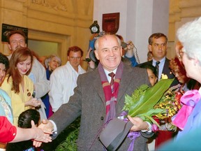 Former Soviet Union president Mikhail Gorbachev arrives at the Palliser Hotel in Calgary in 1993. His daughter, Irina Virganskaya, is on his immediate left. Writer Irena Karshenbaum is on his right in the yellow suit. Photo credit: Victor Panlilio.