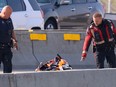 Police investigate a fatal motorcycle collision on the Calf Robe Bridge on  Deerfoot Trail on Sept. 10.