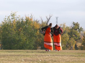 Participants adjust their skirts during Orange Shirt Day ceremonies on Friday.