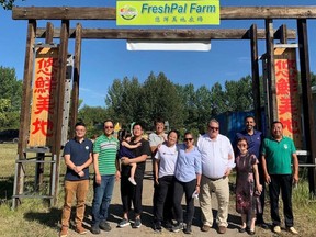 Greenhouse farmer Jianyi Dong, his family and employees greet visiting politicians Deputy Prime Minister Chrystia Freeland and Liberal MP George Chahal at FreshPal Farm in August 2022.