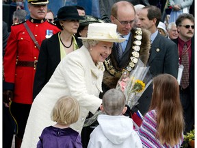 Queen Elizabeth ll is given flowers by children during her walkabout in Churchill Square in Edmonton on May 25, 2005. Edmonton Journal archives