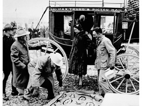 Princess Elizabeth leaving the stagecoach, assisted by Jim Cross, president of the Calgary Stampede Association. Canadian Press photo / National Archives of Canada.