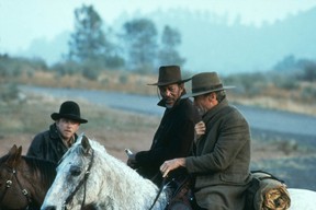 Morgan Freeman and Clint Eastwood as two hardened gunfighters coaxed out of retirement in Unforgiven.