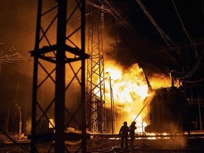 Ukrainian State Emergency Service firefighters put out the fire after a Russian rocket attack hit an electric power station in Kharkiv, Ukraine, Sunday, Sept. 11, 2022. The Kharkiv and Donetsk regions have been completely de-energised in the rocket attack.