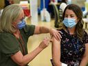 Dr. Karla Gustafson, medical officer of health in the Calgary zone, receives her flu shot at the Richmond Road Diagnostic and Treatment Centre on Monday, October 17, 2022. 