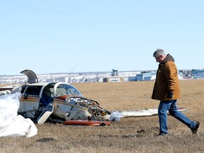 Authorities investigate a fatal plane crash near the Springbank airport on Saturday, April 23, 2022.
