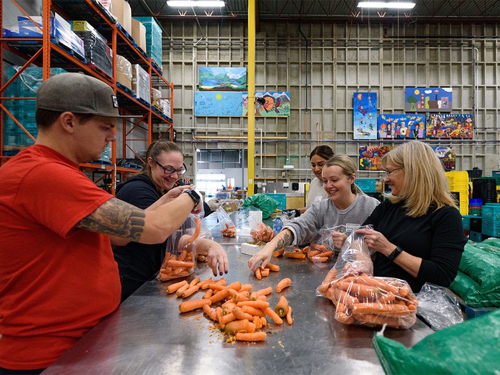  Volunteers sort out fresh foods at the Calgary Food Bank on Wednesday, October 26, 2022.