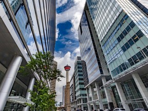 The Calgary Tower is framed by office towers along 9th Avenue SW