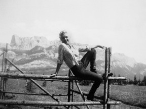 From Mary Graham's A Stunning Backdrop: Alberta in the Movies, 1917-1960, published by Big Horn Books. Marilyn Monroe on a fence at Devona Siding near Jasper, Alberta in "sewn-on" blue jeans for River of No Return in 1953. Bini Furhmann Fonds, v212–pa417–51. Courtesy of the Archives and Library, Whyte Museum of the Canadian Rockies, Banff, Alberta.