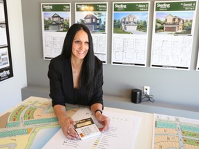 Luiza Paul, a Sterling Homes customer experience manager, helps customers work out a plan for their deposit.