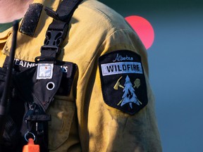 Heather Hawkins, an Alberta Wildfire response officer for the Edson Forest Area, gives an interview at Highway 16 and Highway 22 as Alberta wildland firefighters battle a wildfire between Evansburg and Wildwood on Tuesday, June 22, 2021. Photo by Ian Kucerak