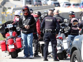 Members of the Calgary Police Violent Crime Suppression Team (formerly the Gang Suppression Unit) are joined by officers as they conduct a traffic stop on Stoney Tr. in northwest Calgary on a busy Canada Day holiday on July 1, 2022.