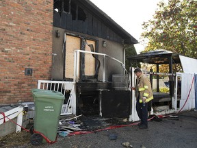 Calgary Fire Department investigators are shown at the scene of a fire on Marwood Circle NE in Calgary on Sunday, October 9, 2022. An early morning fire sent residents of the house to hospital.