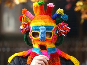 Tom Fleming wears a unique knitted hat during an accessible and inclusive trick-or-treating experience for children with disabilities on 10A St. NW in Kensington in Calgary on Sunday, October 23, 2022.