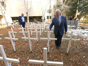 Murray McCann stands among the field of crosses at Dr. John H. Garden Memorial Park installed at Mount Royal University in Calgary on Thursday, October 27, 2022. The crosses remember the 30 students, faculty and staff who have lost their lives serving in the military.