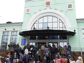 Civilians evacuated from the city of Kherson, which Moscow claims to have annexed, gather at the railway station of the Crimean town of Dzhankoi for futher evacuation into the depths of Russia on October 26, 2022, days after Kherson pro-Russian authorities urged residents of the region's eponymous main city to leave "immediately" in the face of Kyiv's advancing counter-offensive.