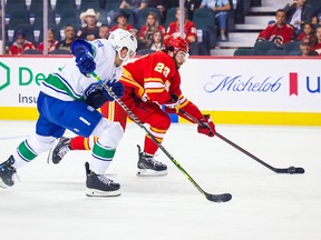 Sep 25, 2022; Calgary, Alberta, CAN; Calgary Flames center Dillon Dube (29) controls the puck against the Vancouver Canucks during the first period at the Scotiabank Saddledome.