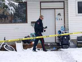 Calgary police investigate a homicide out front of a home in the 100 block of Rundleson Way N.E. in Calgary on Sunday, October 23, 2022.