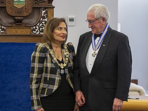 Robert Brawn, from Calgary, receives the Alberta Order of Excellence from Lt.-Gov. Salma Lakhani on Thursday, Oct. 20, 2022 in Edmonton. The award is the highest honour the province offers its citizens.